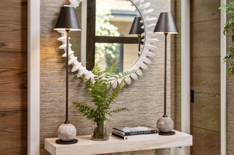 A little contrast, a little texture, and just enough drama to make the whole entryway feel finished. Proof that the right lighting, art, and layered details can turn a simple console moment into something unforgettable. Find pieces to create your own in the QM showroom.

@harborviewcustombuilders 
@phillipjeffriesltd 
@uttermostcompany 
@universalfurn